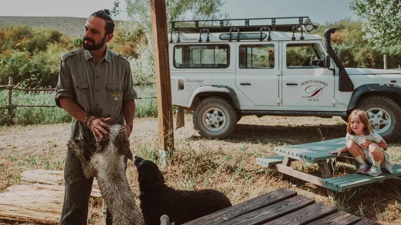 A visitor digging out a truffle with the guide's trained dog near Volterra on a truffle hunting tour in Tuscany